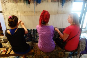 Rita acquiring domestic skills. Weaving a rug by hand, it takes over a million knots and one full year to make.