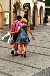 Lovely couple walking along the streets of Munich. A LOT of them dress like this every day for no reason.