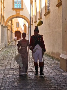Random people walking in Abbey Corridor, at the end is the entrance to the church