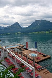 This is the view of the pool, hot tub and lake swimming area. The large pool at the end is solid stainless steel, kept at 86 degrees year round and is floating in the dock, next to it is the cold lake plunge pool, and the little pool under the flags is the hot tub. All floating. Pretty cool.