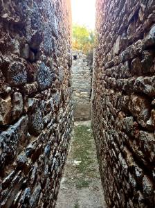 The wall on the left side is the actual Library wall, the wall on the right side was built around the entire library with this air to protect the scrolls from water, moisture, or other elements of weather. Smart builders back then... now a days we call it "Insulation"!