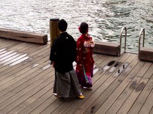 Japanese wedding in front of our hotel, this is part of their photo shoot. Photographer was taking their picture "showing them walking the harbor".