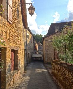 Yes, this is a truck squeezing through these buildings on this very narrow road in our village.