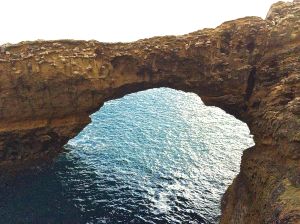 Craggy archway with Atlantic Ocean underneath in Biarritz.