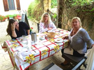Angela trying to de-stress, Mary and Rita coaxing her to chug the wine!! We are at La Chevrefeuille for dinner with Ian and Sara!